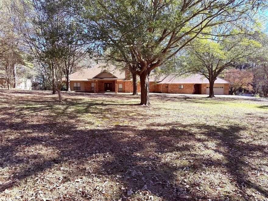 Stunning 3BR-3BA Brick Home on 6.5 Acres – in the East Texas Piney Woods. This spacious home offers exceptional privacy & country living. With almost 3,600 Sq Ft of living space, this property features multiple living areas, upgraded amenities, & room for all your hobbies, equipment, & guests. Interior features 3 living areas, office space, chef’s kitchen with island, tons of storage & cabinets, breakfast bar, wine cooler, & walk-in pantry. Sunken den with great flow from kitchen, 2guest bedrooms, & a large hall bathroom. Large master suite with private attached 'all-season' room. Newly installed security system with cameras. The house also includes a deep water well that furnishes the entire property & carport, plus a huge garage with cabinets & attached work room. Exterior features include, concrete driveway through a large shaded front yard with mature trees. Fully fenced backyard, 30’ x 40’ insulated shop with water, electricity, hot water heater, W-D hookups, half bath & a new 5-ton AC unit to shop. 12x40 covered overhang with concrete slab - perfect for RV, boat, tractor, or equipment storage. Contact the listing agent for a complete list of all recent updates to this property. All conveniently situated between historic Winnsboro & Pittsburg, minutes from Tyler and Longview, approx. 100 miles east of Dallas and 100 miles west of Texarkana. This is a must-see East Texas showplace—schedule your private viewing today!