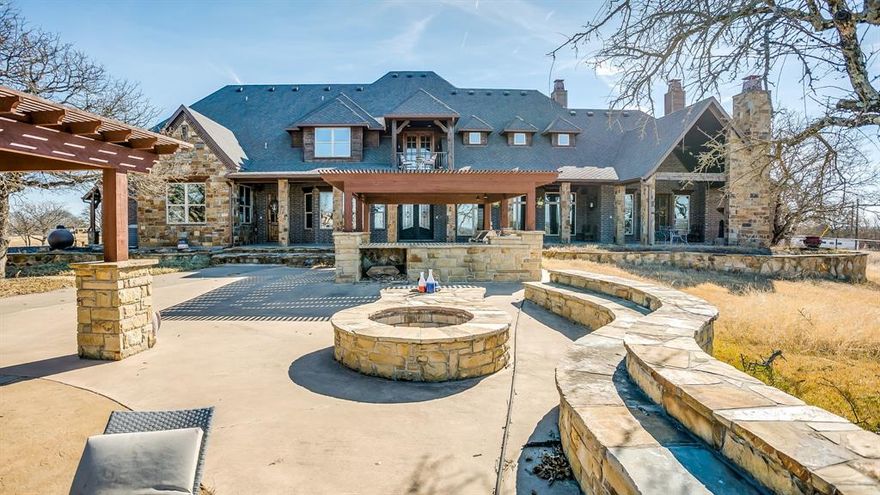 This custom masterpiece is your private oasis outside of the city limits in Brock ISD! Brilliant design features include climate-controlled bedrooms, indoor and outdoor entertainment areas galore including 2 living, 2 media,2 dining, 2 laundry, office, and gourmet kitchen with 2 built in sub-zero refrigerators, commercial grade gas range and sonic ice maker, as well as outdoor kitchen, balconies and a private fireplace directly off of the master suite! Detached workshop is 95x50 with 3 bays and a 1000sf garage apt., 27 fenced acres of pastures, trees and ponds ideal for your horses and livestock to roam! Resort Pool, Firepit and Pool House nestled under a canopy tree are only a few of the exquisite features!