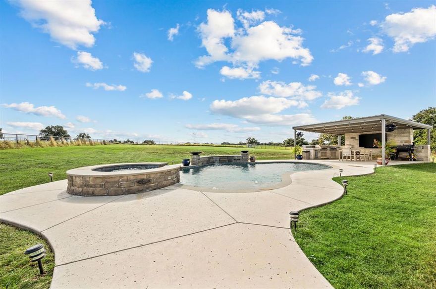 Welcome to 175 County Road 1109 in Decatur, Texas — a beautifully designed modern farmhouse on 2 acres that delivers the peace of country living with an easy commute into the DFW metroplex. Built in 2022 and meticulously maintained, this home blends timeless craftsmanship with today’s most desirable finishes. The open-concept layout features vaulted ceilings, warm natural light, and a cozy brick fireplace that anchors the main living area. The kitchen is straight out of a magazine — granite countertops, custom cabinetry, double ovens, and a hidden back-kitchen pantry that’s as functional as it is impressive. With 4 bedrooms, 3 baths, and over 2,700 square feet, every detail has been thoughtfully planned for comfort, flow, and modern living. The primary suite is a true retreat, complete with a spa-worthy bath and a huge walk-in closet that conveniently connects to the spacious laundry room for everyday ease. Step outside and you’ll instantly feel like you’re on vacation — a pool with spa, outdoor kitchen, and covered patio with fireplace create your private backyard oasis. The buried propane tank efficiently powers the spa, pool, and outdoor living area, making entertaining effortless year-round. The 2-acre lot is fully fenced, so your four-legged friends will love you forever — and if you’ve ever dreamed of adding a few chickens to the mix, they’ll fit right in, too. This home offers the perfect balance of style, space, and serenity — all just a short drive from shopping, schools, and major highways.