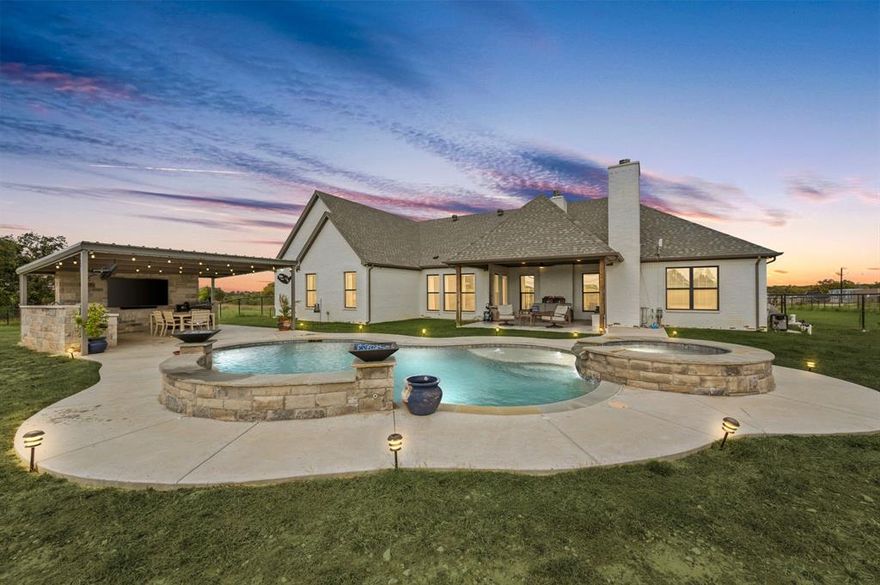 Welcome to 175 County Road 1109 in Decatur, Texas — a beautifully designed modern farmhouse on 2 acres that delivers the peace of country living with an easy commute into the DFW metroplex. Built in 2022 and meticulously maintained, this home blends timeless craftsmanship with today’s most desirable finishes. The open-concept layout features vaulted ceilings, warm natural light, and a cozy brick fireplace that anchors the main living area. The kitchen is straight out of a magazine — granite countertops, custom cabinetry, double ovens, and a hidden back-kitchen pantry that’s as functional as it is impressive. With 4 bedrooms, 3 baths, and over 2,700 square feet, every detail has been thoughtfully planned for comfort, flow, and modern living. The primary suite is a true retreat, complete with a spa-worthy bath and a huge walk-in closet that conveniently connects to the spacious laundry room for everyday ease. Step outside and you’ll instantly feel like you’re on vacation — a pool with spa, outdoor kitchen, and covered patio with fireplace create your private backyard oasis. The buried propane tank efficiently powers the spa, pool, and outdoor living area, making entertaining effortless year-round. The 2-acre lot is fully fenced, so your four-legged friends will love you forever — and if you’ve ever dreamed of adding a few chickens to the mix, they’ll fit right in, too. This home offers the perfect balance of style, space, and serenity — all just a short drive from shopping, schools, and major highways.