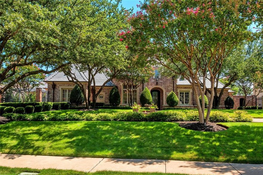 Exquisite 1.5-Story Residence within the Prestigious Guard-Gated Estates of Stonebriar Park. Privately set on a quiet street, this extraordinary residence captures the essence of refined luxury and timeless sophistication. Every detail is thoughtfully designed to balance elegant entertaining with comfortable everyday living. The resort-inspired backyard is a private sanctuary with lush landscaping, a sparkling pool and spa, and a cabana with wood-burning fireplace and refrigerator. The outdoor kitchen includes a grill and sink, while fountains, a mosquito misting system, and fully automated LED lighting elevate the experience. An elevated patio provides multiple areas for dining and relaxation while preserving a generous lawn. Inside, soaring ceilings, plantation shutters, and wide-plank hardwood floors set the stage. Formal living and dining rooms are enhanced with intricate millwork, a butler’s pantry, and a wet bar with ice maker and wine refrigerator ideal for entertaining. The kitchen features marble countertops, premium appliances—including built-in refrigerator, 6-burner gas cooktop, double ovens, and warming drawer—and flows seamlessly into the main living room with striking fireplace, custom built-ins, and backyard views. A richly appointed study with double-sided fireplace and custom cabinetry creates the perfect executive setting. The primary suite serves as a serene retreat, featuring a spa-inspired ensuite with dual vanities, frameless shower, a double-sided fireplace, and a fabulous walk-in closet with direct access to the utility room, complete with abundant cabinetry, sink, and storage. Two secondary bedrooms with Jack-and-Jill bath complete the main level. Upstairs offers a private fourth bedroom with full bath access and a media room with surround sound and wet bar and 2 walk-out attic spaces. A gated motor court leads to a three-car garage with epoxy floors, custom cabinetry, and organizational track system, completing this exceptional estate.