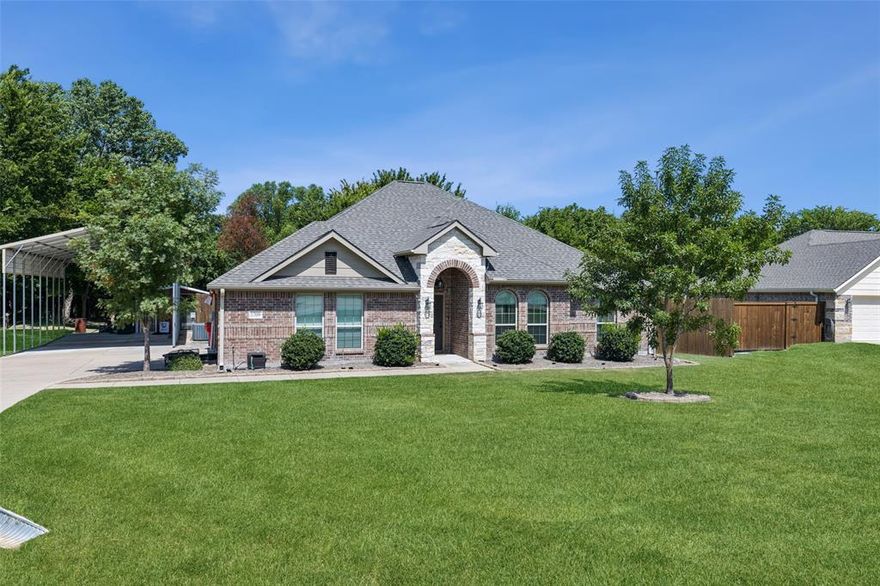 Beautiful and move-in ready, this sprawling one-story home sits on a serene 1-acre private lot on a quiet street. Lender paid buydown available! At the heart of the home is a spacious living room with a stunning stacked stone fireplace and custom built-ins, perfect for cozy gatherings. The chef’s kitchen is a dream—featuring a large island with breakfast bar, walk-in pantry, and a bright, sunlit breakfast room. The tranquil primary suite offers bay windows and a spa-like ensuite with dual sinks, a garden tub, and a large walk-in shower. Rich and on-trend luxury vinyl plank flooring was installed in 2022 throughout most of the home, adding warmth and durability. Outdoors, an extended driveway leads to an RV carport with electrical hookups—ideal for RV parking or up to four vehicles—plus a two-car attached garage. A large metal building with water and electric is perfect for added storage or use as a kennel. Major updates include a new roof (2024) and a recently replaced water heater. Enjoy peaceful mornings on the covered patio overlooking the expansive backyard that backs to trees and nature. All homes on this quiet street were built around the same time, creating a cohesive and welcoming community feel. Convenient to schools and amenities, this property offers a rare blend of privacy, functionality, and charm. Don’t miss your opportunity to make this exceptional home yours!