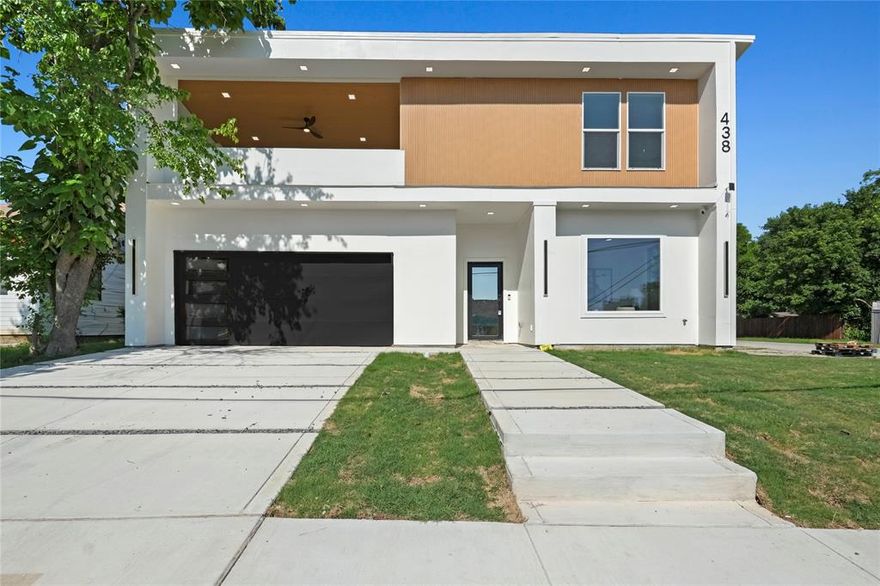 Buyers receive $9,843 lender credit with the preferred lender to go towards closing cost and $10,000 Seller Concession. Welcome to this stunning new modern home located just minutes away from downtown Dallas and the vibrant Bishop Arts District. As you step inside, you'll be immediately captivated by the open floor plan, ideal for entertaining guests. The living area features a striking ceramic tile fireplace and is accentuated by soaring 12-foot ceilings.The kitchen, boasts a luxurious quartz waterfall island, a massive walk-in pantry, and a dedicated wine cellar. This home offers a total of five bedrooms, with four conveniently located on the main level. The primary bedroom is a true sanctuary, with an expansive layout. The primary bathroom is designed for ultimate relaxation, featuring a walk-in shower, a stand-alone soaking tub, and an enormous walk-in closet. Upstairs, you'll find an additional room and a covered balcony, providing a serene spot to unwind and enjoy the outdoors.