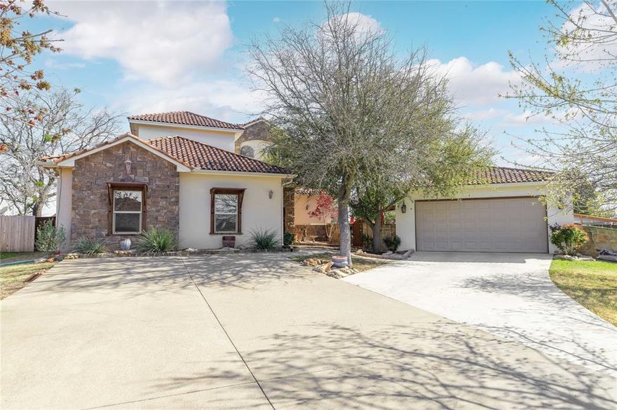 Beautiful mediterranean style 2 story custom home with 5BR, 4B plus many amenities & special features. Spacious entryway leads into a large living area with a gas log fireplace & is open to a formal dining room which can easily 10 or more guest. The gourmet kitchen features SS appliances., granite counter tops, breakfast bar, a unique vent hood & 2 pantries. The primary BR is large with direct excess to the patio-pool & features a huge walk-in shower plus a jetted tub with waterfall. There is an additional second living area-guest BR with 4 built-in bunk beds. Upstairs includes 2 spacious bedrooms with full bath & a covered patio overlooking the pool and downstairs courtyard. The 5th BR is separate from the house & is accessible from the pool-patio area. This guest suite could also be a great private home office. The heated pool features waterfalls & hot tub. There are also 3 patio areas & an outdoor kitchen. The oversized 2 car garage has an attached large shop with overhead door for access and A-C. The roof is high quality Spanish tile. This home has something for every buyer and is one of the most unique homes of Elk Ridge Estates in Stephenville.