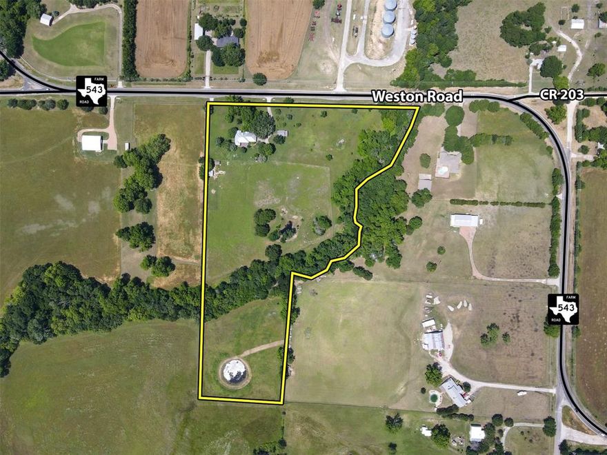 Prime unrestricted 12.96 acres for investment or future development just northwest of McKinney featuring mature trees, a quality home, stunning views, and a creek. Known as Roland Farm, this property boasts excellent frontage, rolling terrain, a separate insulated workshop with heating, air conditioning, and 220V power, ponds, and a wooded creek along the east boundary. The home is shaded by large trees and offers a priceless view from the spacious back porch and Trex decking. This charming home is well-maintained with a standing seam metal roof, generously sized rooms, and an open living area with beautiful views. It includes a Thermador gas range, a large pantry, and ample storage. The three-car garage is divided into a regular two-car space and a third area used as a finished workspace with HVAC. The land features a water well, a 1500-gallon supply tank, a garden shed, a livestock shed, and a hen house. This exceptional location is approximately 5 miles northwest of McKinney.