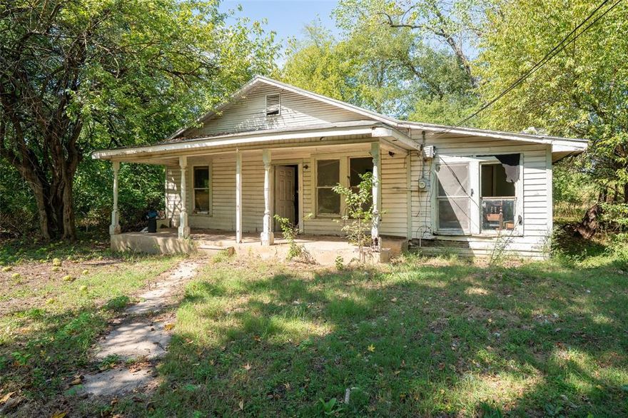 Fixer-upper opportunity! This 3-bedroom, 1-bath home has just under 1,000 sq. ft. with a kitchen, dining, living room, and separate utility room all of which need work. Sitting on a large lot with mature shade trees and over 100 feet of road frontage, the property also boasts a wide country porch perfect for future charm. The home needs updating and repair, but with solid bones and great potential, it’s the perfect project for investors, handy homeowners, or flippers ready to bring it back to life.