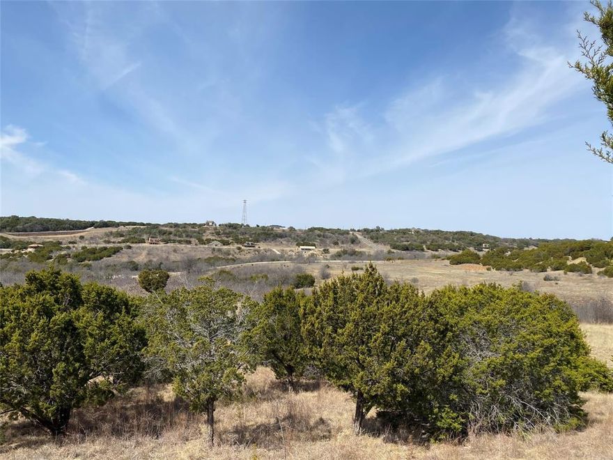 High on a hill overlooking The Hills neighborhood. The sweeping view takes in the northern end of Possum Kingdom Lake and most of the neighborhood. This lot slopes gently away from the road towards the north. Lot ownership permits use of all the neighborhood amenities including; boat storage area, clubhouse with pool and fitness center, picnic area and cabin, private fishing pond and 20 miles of private roads behind the gates.