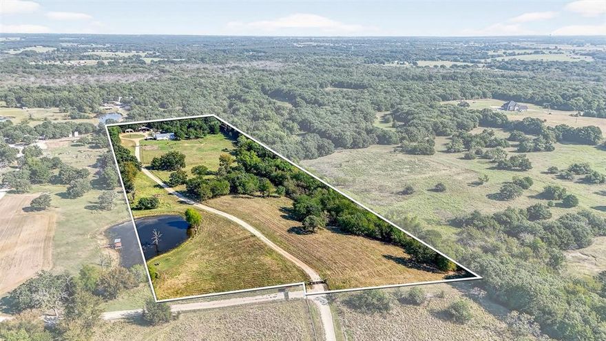 Discover 10.8 acres of beautiful North Texas land offering the perfect mix of mature oak trees, open space, and functional improvements. This property is ideal for those looking to build, expand, or create a private homestead with room to grow. The land features a balance of shaded areas and usable acreage, providing flexibility for livestock, gardening, recreation, or future development. A shared stock pond adds both scenic appeal and practical use, while the natural layout offers multiple possibilities for homesites, outdoor living, or additional structures. Well-equipped with valuable amenities, the property includes a private well house, greenhouse, storm cellar, and a two-bay workshop with electricity—perfect for equipment storage, hobbies, or small-scale operations. Covered RV and boat storage adds even more convenience for those needing space for recreational vehicles. A move-in-ready 3-bedroom, 2-bath home sits on the property, offering immediate use while you plan your long-term vision. With its combination of natural beauty, usable land, and existing infrastructure, this property delivers a rare opportunity to own acreage that’s ready to enjoy today and build on for the future—all while being conveniently located near nearby towns and amenities.