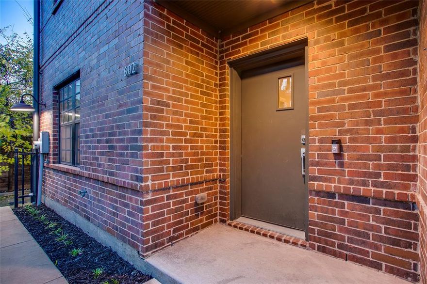 Located just steps from the Bishop Arts District, this corner unit 3-story luxury townhome was built to reflect the history of the neighborhood. Exterior features include gorgeous red brick, expansive warehouse windows, and a beautiful rooftop patio with a cedar pergola ideal for relaxing and entertaining. Offering ultimate privacy, and a plethora of natural light, you'll love the lofty floorplan. Noteworthy features include concrete floors on the first floor, spacious rooms, and a gorgeous open living and dining area on the 2nd floor with walls of windows. The 3rd-floor owner's suite is the ultimate retreat with a custom closet and access to the rooftop patio. An unbeatable location near desirable amenities!