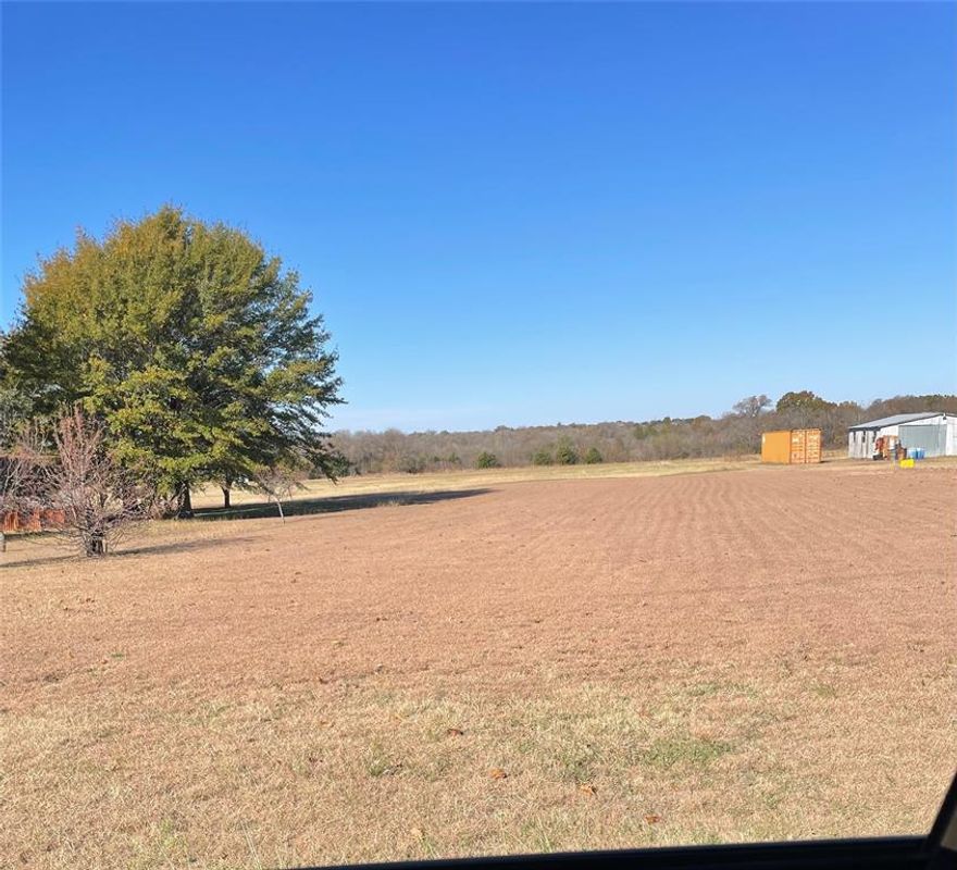 Very nice land, great location right off I45.  Great hay field, some trees.  Mobile home to be moved. there is no value in home. Land has workshop or storage building. Freight container does not stay. Water, electricity and septic already in place, just waiting for you! Please park at the mobile home if you have an appointment to show the land. Please call agent to make appointment to show. No survey, buyer will have to get new survey if needed