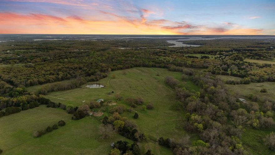 Welcome to an extraordinary luxury ranch retreat and investment opportunity at 3647 County Road 265 in Collinsville, Texas—where privacy, scale, and natural beauty converge across more than 73 acres of prime North Texas land.

A picturesque private driveway leads you into a secluded setting defined by rolling hills, dramatic elevation changes, and sweeping prairie views. This property offers a rare blend of refined rural living and long-term investment potential, ideal for a private estate, luxury retreat, recreational ranch, or future development hold.

The land features a tranquil pond, enhancing both the aesthetic appeal and functional value for livestock and wildlife. With multiple elevated build sites, the property is perfectly suited for creating a custom luxury residence or multi-structure retreat compound designed to capture panoramic views in every direction.

Adding to its exclusivity, the property adjoins over 140 acres of Army Corps of Engineers land, providing extended privacy, protected surroundings, and a natural buffer that significantly enhances long-term value.

From an infrastructure standpoint, the property is fully fenced, including approximately 1,000 feet of pipe and metal fencing, and is already equipped with water and electricity on-site—a major advantage for immediate use or future development. A storage structure for tractor and equipment is included offering turnkey functionality for ranch operations or land management.

Whether you’re seeking a private luxury escape, a weekend retreat with income potential, or a strategic land investment in a rapidly growing North Texas corridor, this property delivers a compelling combination of beauty, utility, and upside.