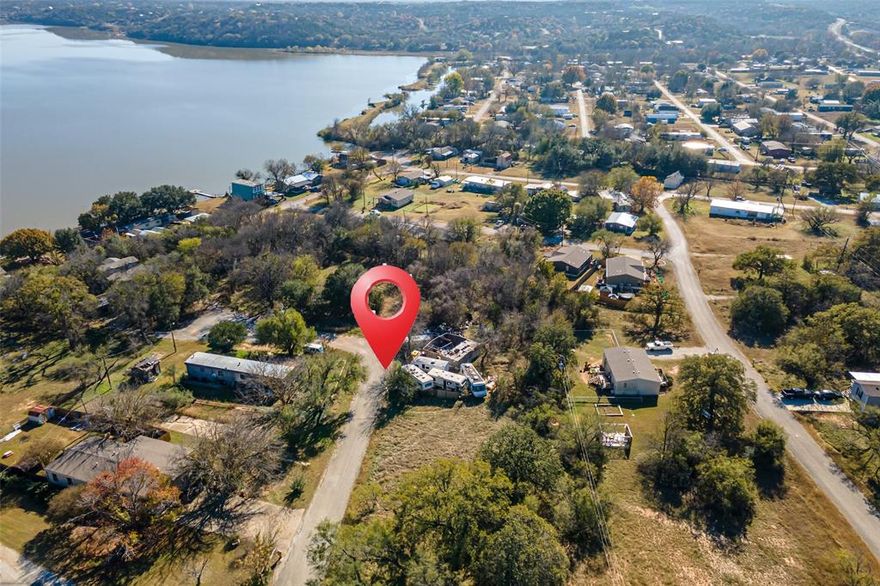 Residential lot in Arrowhead Shores. Can place a manufactured home on the lot or build a home. Lot to the left of this one is also for sale. Discount offered if you buy both lots! Bring your offer! Very low cost HOA. Offers a private boat ramp on Lake Granbury, community pool, clubhouse, park, and convent access to Granbury and Weatherford.
