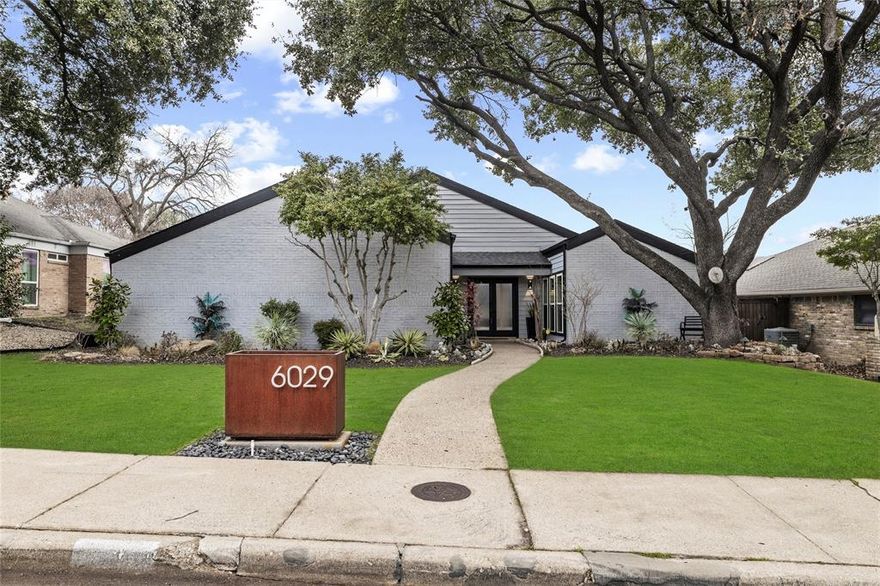 Striking architecture, dramatic vaulted ceilings, and a private courtyard create an unforgettable first impression in this one-of-a-kind Prestonwood home. Zoned to highly sought-after Brentfield Elementary and Pearce High School, this architecturally distinctive home blends modern updates with timeless design. The dramatic main living space features vaulted ceilings, exposed beam detail, and a striking floor-to-ceiling painted brick fireplace, all surrounded by expansive windows that showcase the home’s private interior courtyard.
The updated kitchen delivers a bold, moody aesthetic with rich dark cabinetry, sleek countertops, stainless appliances, and a functional center island. The kitchen flows seamlessly into the dining and living spaces, creating an ideal layout for everyday living and entertaining. A dedicated wet bar overlooks the living area and courtyard, adding an elevated entertaining feature rarely found in the neighborhood.
Designed around indoor-outdoor living, the private courtyard offers a peaceful and stylish retreat with modern finishes, string lighting, and multiple seating areas. The backyard continues the entertainment appeal with a heated pool and spa, providing year-round enjoyment and a true extension of the living space. 
Situated on a quiet, tree-lined street, this established Prestonwood neighborhood offers mature landscaping, strong community appeal, and convenient access to major North Dallas employment corridors, dining, shopping, and entertainment.