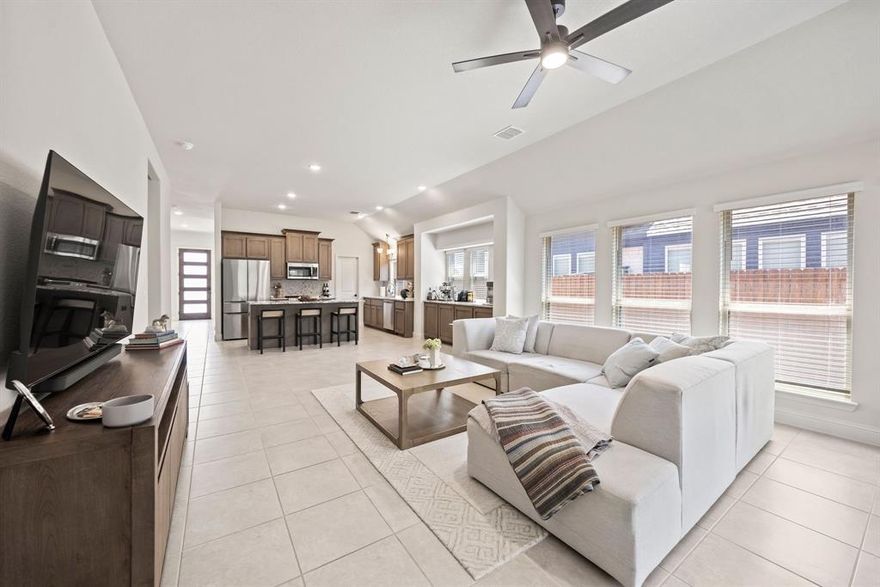 Welcome home to this inviting and impeccably maintained 4-bedroom, 3-bathroom home, designed for modern living and effortless entertaining. The moment you step inside, you'll be greeted by an abundance of natural light streaming through the expansive windows, highlighting the high ceilings and open-concept layout. The main level boasts beautiful tile flooring throughout the living, dining, and kitchen areas, with cozy carpeting in the three downstairs bedrooms. This floor plan provides flexible spaces for gatherings of all sizes. The heart of the home is the stunning kitchen, a chef's dream with gleaming granite countertops, a large center island with seating, and stainless steel appliances. You'll find ample counter and cabinet space, making meal preparation and storage a breeze. The primary suite is a true retreat, offering a tranquil sanctuary with a luxurious en-suite bathroom. The primary bedroom also includes a dedicated sitting area, perfect for unwinding with a good book. Indulge in further relaxation with a large garden tub, a separate shower, and dual sinks. Upstairs, a versatile gameroom serves as the second living area, perfect for movie nights, a dedicated kids' play area, or a great space to watch the big game. This level also includes a bedroom and a full bath, providing an ideal private space for guests or a family member. Step outside to discover your own private oasis. The covered back patio is perfect for enjoying a quiet morning coffee or hosting a lively BBQ. The very large backyard offers plenty of room for outdoor activities, whether it's for kids to play, dogs to run, or for adding a future pool. This home is a must-see for anyone looking for a clean, well-maintained property that feels like new. Conveniently located with easy access to major highways, shopping, and dining, this home offers the perfect blend of comfort and accessibility.