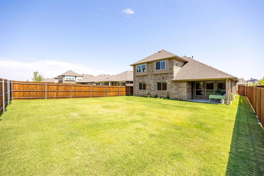 Welcome home to this inviting and impeccably maintained 4-bedroom, 3-bathroom home, designed for modern living and effortless entertaining. The moment you step inside, you'll be greeted by an abundance of natural light streaming through the expansive windows, highlighting the high ceilings and open-concept layout. The main level boasts beautiful tile flooring throughout the living, dining, and kitchen areas, with cozy carpeting in the three downstairs bedrooms. This floor plan provides flexible spaces for gatherings of all sizes. The heart of the home is the stunning kitchen, a chef's dream with gleaming granite countertops, a large center island with seating, and stainless steel appliances. You'll find ample counter and cabinet space, making meal preparation and storage a breeze. The primary suite is a true retreat, offering a tranquil sanctuary with a luxurious en-suite bathroom. The primary bedroom also includes a dedicated sitting area, perfect for unwinding with a good book. Indulge in further relaxation with a large garden tub, a separate shower, and dual sinks. Upstairs, a versatile gameroom serves as the second living area, perfect for movie nights, a dedicated kids' play area, or a great space to watch the big game. This level also includes a bedroom and a full bath, providing an ideal private space for guests or a family member. Step outside to discover your own private oasis. The covered back patio is perfect for enjoying a quiet morning coffee or hosting a lively BBQ. The very large backyard offers plenty of room for outdoor activities, whether it's for kids to play, dogs to run, or for adding a future pool. This home is a must-see for anyone looking for a clean, well-maintained property that feels like new. Conveniently located with easy access to major highways, shopping, and dining, this home offers the perfect blend of comfort and accessibility.