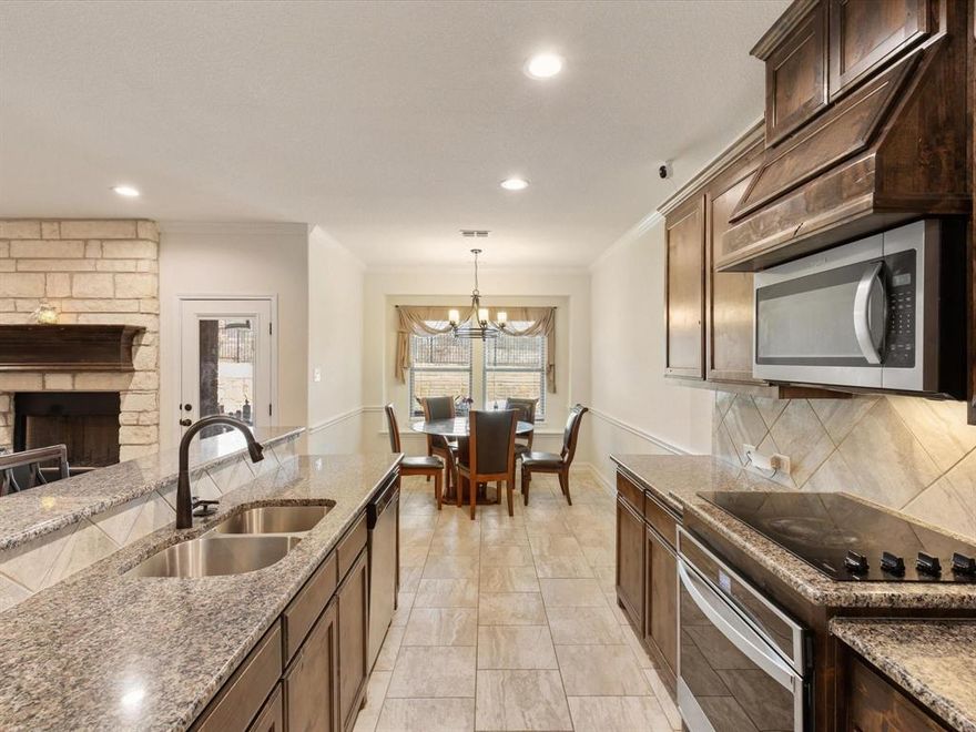 An assumable 2.875% interest rate may be available to qualified buyers, making this home an exceptional opportunity. Built in 2021 by Ashton Homes, this modern 4-bedroom, 3-bath residence sits on an oversized lot in the sought-after Oak Hills subdivision of Burleson. The open-concept design showcases luxury vinyl plank and tile flooring throughout, no carpet, and a spacious family room anchored by a cozy fireplace that flows into a chef’s kitchen with granite countertops, stainless steel appliances, a large pantry, and an inviting island for gatherings. The main level features a private guest suite, dedicated home office, and a luxurious primary suite with an oversized walk-in closet, dual vanities, and a walk-in shower. Upstairs offers two additional bedrooms and a full bath, creating flexibility for family or guests. Outside, enjoy a private backyard with a covered patio ideal for relaxing or entertaining. Experience the best of Burleson living—minutes from shopping, dining, and recreation, all within the award-winning Joshua ISD.