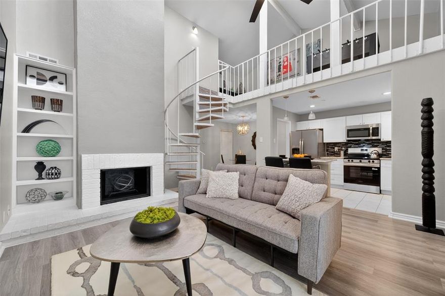 Set in a vibrant, resort-style community packed with top amenities such as two pools, jogging trails, dog parks, & two sets of courts for tennis, basketball, & pickleball. Beautifully updated and full of character, this Dallas townhome offers the perfect blend of modern upgrades, flexible living space, and timeless architectural charm. Nestled beneath mature trees in an established community, this move-in ready home immediately stands out with its private gated courtyard entrance, soaring ceilings, and dramatic open-concept layout. Inside you’ll find updated luxury vinyl flooring, fresh modern finishes, oversized windows that flood the home with natural light, and a stunning spiral staircase that creates a true focal point in the living area. The remodeled kitchen features white shaker cabinetry, granite countertops, stainless steel appliances, recessed lighting, designer backsplash, and breakfast bar seating overlooking the main living space.

The spacious living room showcases impressive vaulted ceilings and an airy loft overlook, creating an open feel rarely found at this price point. Upstairs loft area offers endless possibilities for a media room, game room, second living area, home office, or workout space. Large primary suite offers generous square footage, dual windows for natural light, updated flooring, and direct access to the beautifully renovated bathroom featuring modern tile work and updated fixtures. Additional highlights include updated lighting throughout, dedicated laundry space, abundant storage, and flexible floorplan options ideal for today’s lifestyle.

Step outside to enjoy a private fenced backyard shaded by mature trees with patio space perfect for entertaining, relaxing, pets, or gardening. The home also offers excellent curb appeal with mature landscaping and a welcoming front courtyard entrance. Conveniently located near major highways, shopping, dining, and entertainment with quick access throughout Dallas.