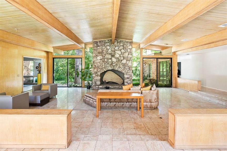 Architecturally Iconic Mid-Century Modern on Creekside Cul-de-Sac

Tucked away on a rare cul-de-sac lot backing to a serene creek, this mid-century modern jewel box is ultra-cool. Custom-built in 1966 by a prominent Dallas developer, the home is a rare architectural treasure. Designed by acclaimed Dallas icon Gerald Tomlin, who was a regular appraiser on Antiques Roadshow and won numerous awards, this property was featured in both Architectural Digest and The Dallas Morning News as a testament to Southwest midcentury modern design.

Walls of glass dissolve the boundary between indoors and out, illuminating generous living spaces beneath soaring tongue-and-groove wood ceilings. At its heart, a dramatic sunken living room anchors the home—centered on a monumental stone fireplace and mirrored by another on the back terrace—creating an opportunity for indoor-outdoor living surrounded with views of the lush, creekside landscape and beyond, to a private island in the rear.

The primary suite includes its own sunken sitting area, stone fireplace, and direct access to the verdant grounds. You will want to remove the sheetrock, to reveal the original brick wall. Discovering architectural treasures is half the fun of rescuing a midcentury modern!  

A separate full apartment—complete with living room, kitchen, bedroom, and bath—provides ideal accommodations for guests or multi-generational living.

There is very little that is more satisfying to someone that truly understands the midcentury era, than restoring a home to its former glory.  This is a project, but what an extraordinary opportunity to own and preserve an architecturally significant piece of Dallas history.