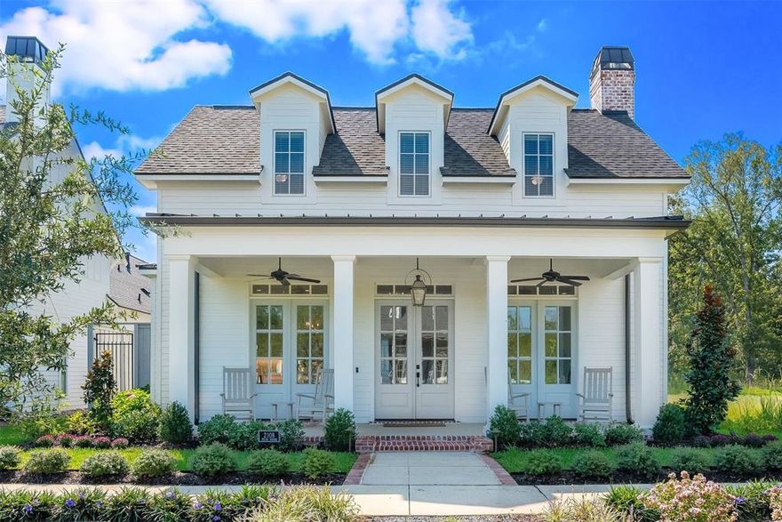 This custom-built, like-new construction home combines timeless curb appeal with modern comfort in the heart of Provenance. Overlooking the new horseshoe park in Phase 4, the property features a full front porch with a metal roof, ceiling fans & room for rocking chairs, all framed by dormer windows and professional landscaping that set the stage for warm Southern living. Inside, the open and light-filled floor plan offers soaring ceilings and a seamless flow between the Chef’s Kitchen, dining, and living areas—perfect for entertaining or everyday life. The kitchen is a true showpiece, with to-the-ceiling cabinetry, an oversized island with seating and storage, quartz countertops, a pot filler, GE stainless steel appliances, and a gas cooktop. The Formal Dining area flanks the Kitchen. A private office, nursery, or gym with a closet on the main level adds flexibility to suit your lifestyle. Mud bench. Utility room with sleek tile, ample cabinetry, and utility sink. The primary suite serves as a private retreat with a soaking tub, double vanities, linen towers, and custom walk-in shower. Upstairs, a spacious landing connects two generously sized bedrooms & a full bathroom, offering comfort and privacy for family or guests. Throughout the home, you’ll find built-ins in every closet, while the floored attic provides additional storage. Outdoors, enjoy quiet evenings on the expansive porch or host gatherings in the private fenced side yard & patio courtyard, enhanced with cozy seating, string lighting, & grilling space (with attached grill). A 2-car garage with additional room for a golf cart adds everyday convenience to this already exceptional home. A rare find, this residence blends modern convenience, elegant design, and an unbeatable location—ready for its next chapter. Walk or ride a golf cart to Rhino coffee shop, restaurants, bank, post office & events. Enjoy a wonderful way of life in Provenance, including access to the neighborhood pool, parks, clubhouse & gym.