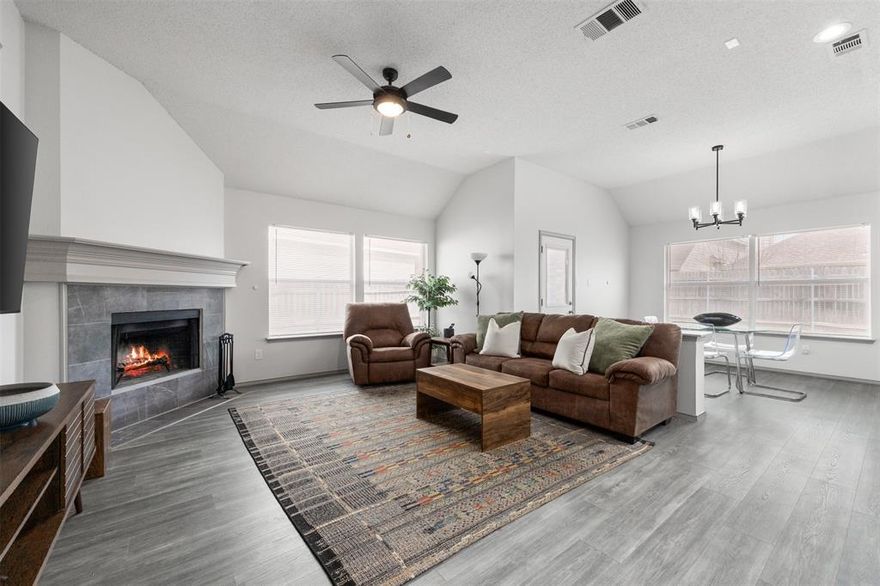 Stylish and completely updated, this beautiful home features an inviting covered front porch. The open floor plan with high ceilings creates the perfect space for entertaining. The spacious living room is centered around a cozy fireplace, while the modern kitchen boasts granite countertops, beautiful backsplash, stainless steel appliances, a pantry, and island. The primary suite offers a walk-in closet and a spa-like bath with double sinks, a jetted tub, and a subway-tiled shower. Three additional bedrooms provide ample closet space, while the full bathroom showcases sleek granite countertops. Updated lighting and ceiling fans enhance the home throughout, complemented by luxury vinyl plank flooring. An oversized garage offers ample storage, and the fenced backyard provides plenty of space to relax and enjoy.