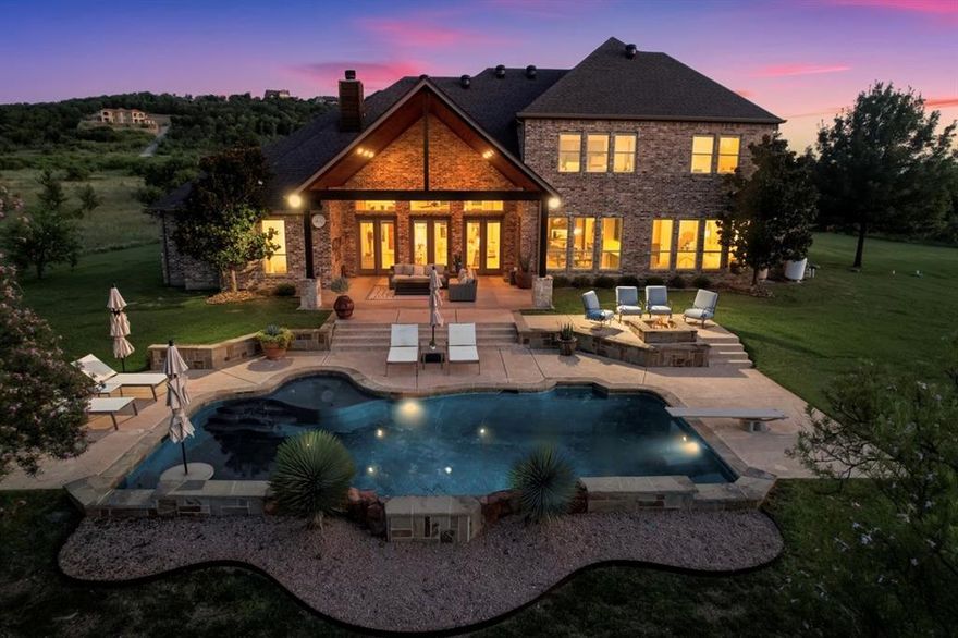 Discover the perfect blend of comfort, style, and thoughtful design in this stunning 4,172 sq. ft. home—where relaxed luxury living becomes your everyday reality. Every detail has been carefully curated, from gleaming hardwood floors to upscale finishes that create a welcoming yet refined atmosphere.
With up to 5 spacious bedrooms—including 3 private en-suites—there’s plenty of room for family, guests, or a dedicated home office or workout room. The heart of the home is the beautifully designed kitchen, complete with professional-grade appliances, custom cabinetry, double islands, a walk-in pantry, breakfast bar, prep sink (or wet bar), and a built-in buffet with wine fridge—perfect for entertaining with ease.
Open-concept living and dining spaces flow effortlessly for everyday living and special gatherings alike. Upstairs, a generous second family room offers even more flexibility for relaxing or hosting guests.
The 270 sq. ft. primary suite is a true retreat, offering spa-like serenity and an abundance of closet space. Step outside to enjoy your own private paradise—an inviting covered patio, a sparkling pool, and a cozy fire pit area ready for stargazing or late-night conversations.
Tucked inside the highly desirable Hills Above Possum Kingdom, this property offers the rare combination of peaceful privacy with convenient access to the lake and community amenities. Whether you’re looking for a forever home, a weekend escape, or a place to host the people you love most, this property delivers.
This is more than just a home—it’s a lifestyle. Come see what makes it so special.