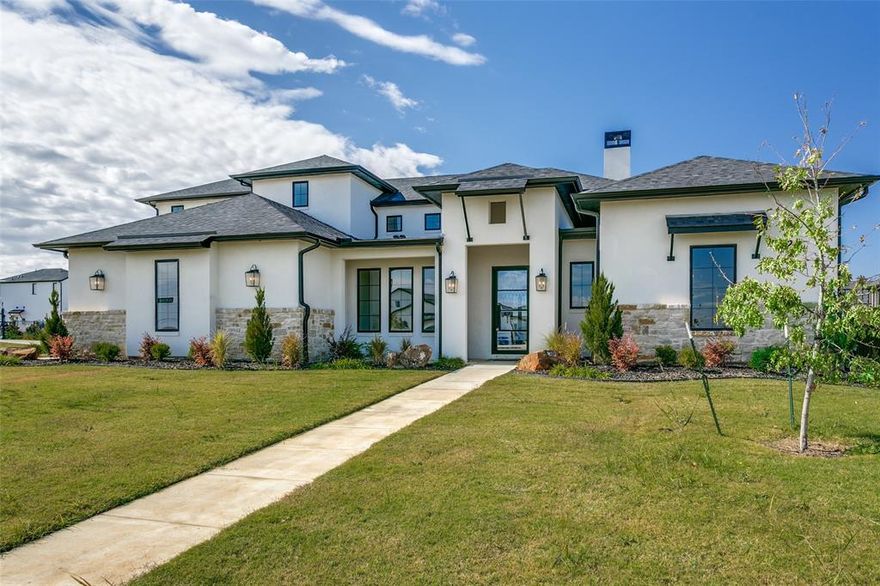 Beautiful Modern Transitional home on large lot in The Vines of Haslet built by PentaVia. Open floor plan, wide plank hardwood floors, gorgeous lighting, premium quartz countertops, a soft color palette. Gourmet kitchen with GE Cafe SS appliances, gas cooktop, center island, elegant white silage tile backsplash, and custom cabinetry. Family room features wood beamed ceiling and spectacular fireplace with floor to ceiling stone surround. Primary suite is spacious and offers a spa like bath, custom mirrors, large soaking tub and separate shower. An additional 4 bedrooms with 4.1 baths are positioned throughout the home to give amazing privacy. Spacious game room with full kitchen is located just off the kitchen area and is perfect for showing the big game or movie night with the family. Outdoor covered patio is large and offers a built in gas grill. Large yard can easily accommodate a pool with plenty of room for a game of soccer or a play set. Walking trails, a playground, a pavilion, and a catch and release pond. Completion late late July 2025.