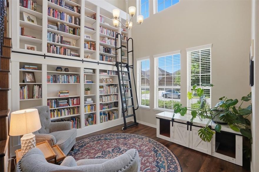 Step into a home where every detail tells a story and every space invites connection. Perfectly positioned in McKinney with peaceful lot that back to the greenbelt, this beautifully designed 4-bedroom, 3-bath home stands apart from the rest with custom features and unforgettable personality throughout.
The front flex space immediately steals the show with stunning built-in bookshelves complete with a rolling library ladder — creating the perfect home office, reading retreat, or creative studio. Designer touches continue around every corner, from the custom dining banquette that makes everyday meals feel special to the thoughtfully curated finishes that bring warmth and character to each room. Even the laundry room delivers a dose of joy with elevated style and charm.
The functional floorplan offers both comfort and flexibility with the primary suite and a secondary bedroom downstairs, ideal for guests or multigenerational living. Upstairs, you’ll find two additional bedrooms, a spacious game room with more custom built-ins, and a dedicated media room ready for movie nights and game days.
Outside, the backyard was intentionally designed for gathering and conversation. Enjoy an extended patio, low-maintenance turf grass, and serene location in the neighborhood that creates a private and inviting outdoor retreat.
This is more than a home — it’s a thoughtfully crafted lifestyle filled with charm, functionality, and standout design in one of McKinney’s most desirable settings.