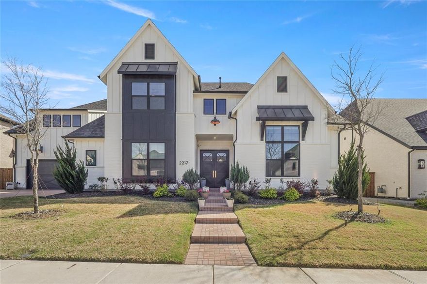 Experience elevated living in the acclaimed master-planned community of Mustang Lakes with this exceptional north-facing luxury home built in 2023. Offering 6 bedrooms, 6 full baths, 1 half bath, and 5,355 square feet, this move-in ready residence blends timeless elegance, modern functionality, and thoughtful upgrades throughout. Step inside to soaring ceilings, designer lighting, premium flooring, beam ceiling details, and expansive living spaces designed for both everyday comfort and effortless entertaining. The open-concept layout creates seamless flow between the kitchen, dining, and family room, while dramatic sliding glass doors extend the living experience outdoors. The gourmet kitchen is a true centerpiece with abundant prep space, upscale finishes, and a premium Thermador 30-inch double column refrigerator and freezer that conveys with the home. Each bedroom offers privacy and flexibility for guests, multigenerational living, work-from-home needs, or additional media and game space. The spacious primary suite is a private retreat with a spa-inspired bath designed for relaxation and comfort. Additional features that set this home apart include whole-home shades, back patio sunshade, a whole home Aquasana water filtration system, epoxy garage flooring, 2 GE washer and dryer sets, projector and screen, and 4 mounted TVs located in the living room, primary bedroom, game room, and backyard. Located in one of Celina’s most desirable communities, Mustang Lakes offers exceptional amenities including resort-style pools, fitness center, clubhouse, trails, parks, ponds, tennis and basketball courts, all within highly regarded Prosper ISD. This is a rare opportunity to own a nearly new luxury home with designer character, functional space, and meaningful turnkey value already in place.