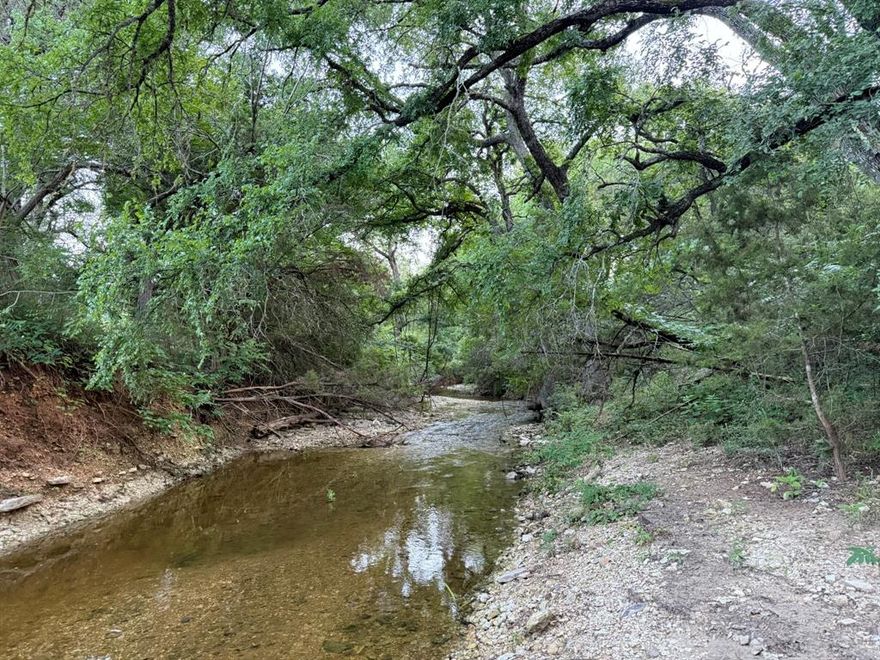CORYELL CREEK RANCH.  A beautiful 1,856-acre Central Texas Legacy Ranch located just 22 miles west of Waco and 75 miles north of Austin. This high-fenced legacy ranch is lightly managed and under low hunting pressure. A central feature is the Clear Branch Creek—a tributary of Coryell Creek—that flows into a spectacular 30+ acre man-made lake stocked with bass and frequented by waterfowl. The property also benefits from an agricultural exemption, with cattle on-site.

The ranch offers a wide range of terrain with an excellent road system to enjoy it all.  I estimate 25% of the ranch is woody tree canopy, 25% open grassy plain, 10% terraced pasture, with the balance being native pasture with nice sporadic hardwoods.  The elevation ranges from 780' at the creek below the lake dam to 940' at the terraced pasture along the north boundary.   Stunning rolling terrain!

The deer heard is native central Texas whitetails.  To my knowledge there has been no commercial hunting or breeding on this property. Game management would be up to the new owner.  Start fresh or work with the existing population. 

The lake is spectacular.  The west bank looks like a park with a gentle sloping grassy bank and large Cedar Elms creating the perfect picnic spot.  Water comes into the lake at the north end (Clear Branch Creek) where you will find old tree trunks standing the test of time and creating structure for bass.  I am told the record bass weighed in at 14lbs.  Again, you can work with the existing fish population or begin your own management plan.  Built by a prior land owner in 2004, the lake is simply spectacular and certain to provide you and your family endless entertainment.

Coryell Creek Ranch is perfectly suited for a family seeking a generational legacy property. Whether your goals include hunting, cattle ranching, fishing, or simply exploring the outdoors, this ranch is ready for your vision.  PHOTOS DO NOT DO THIS RANCH JUSTICE.
