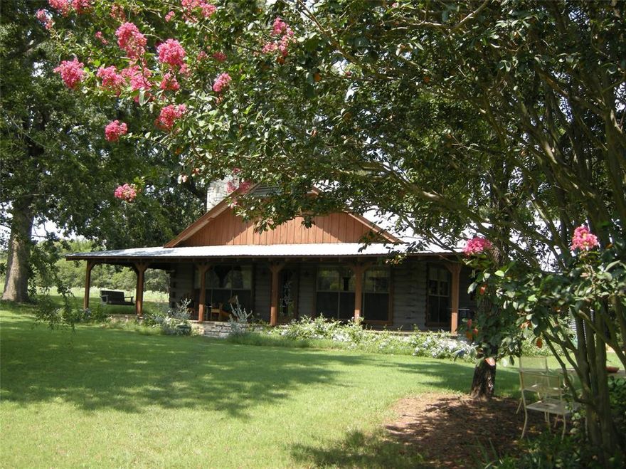 MOTIVATED SELLER doesn't want you to miss an opportunity to see this beautiful property! Charming SATTERWHITE LOG HOME on 130+ rolling acres. Stunning setting is ideal for those looking to escape to the country, start a farm or ranch, or simply enjoy the peace and beauty of East Texas.  Property includes log home, workshop-barn, hay barn, well, corral, fenced & crossed fences, 5 ponds-lake, rolling hills, well for watering garden and so much more! One lake is 5+ ac. Home features an expansive covered porch & enclosed back porch, ideal for taking in the breathtaking countryside views.  Inside, you’ll find a warm and inviting living space with a gorgeous stone fireplace, large windows, 4 comfortable bedrooms, plus hall cedar closet. Spacious kitchen with eat-in dining rm, huge laundry-storage rm plus ample storage throughout.  Maintenance is easy with stained concrete flooring.  Wood ceilings & walls create a cozy vibe!  Property includes two large barns that are perfect for storing equipment or serving as workshops. Whether you’re looking to expand your agricultural operations or need space for hobbies and projects, these barns provide the room you need.  The property is equipped for ranching, self-sufficiency & reliability with a greenhouse, generator and propane storage. Water is plentiful, with 5 ponds and a well that provides garden irrigation.  A propane tank and generator ensure reliability.  The property has approx 3000' of road frontage providing great access.  Additional features include a two-car carport and lots of storage off the enclosed patio.  The land is currently leased for cattle. There is the potential for continuation of the lease, making this an excellent investment for ranchers or those seeking a peaceful retreat with income potential.  Land is a mix of open pasture, wooded areas and ponds.  The land & buildings on this ranch are very well maintained. Spend hours exploring trails & gorgeous sunsets! Award Winning Lindale ISD. A Real E Texas GEM!