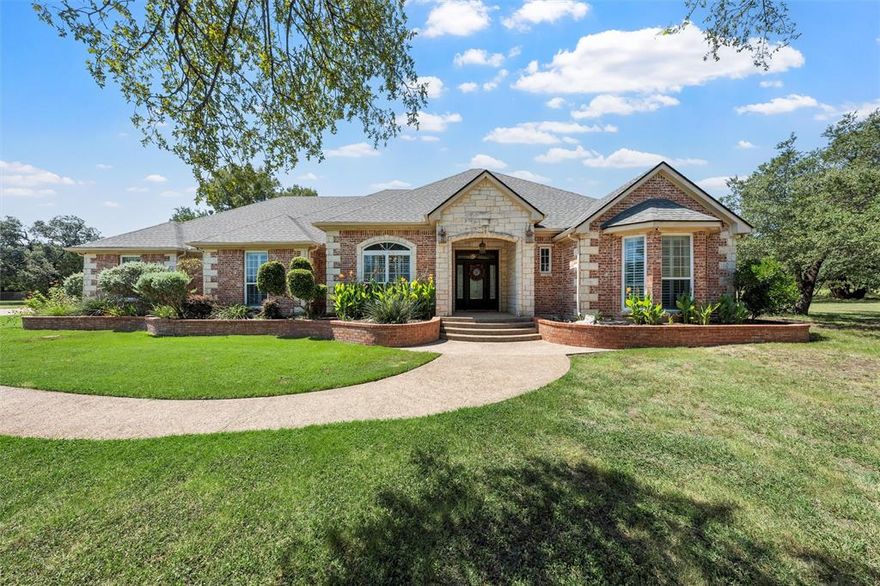 Discover the epitome of elegance in this stunning Crawford, TX estate, perfectly situated on 1.89 acres in the serene landscape of the Three 17 River Oaks subdivision in Crawford ISD. This exceptional home features 4 spacious bedrooms, 3.5 baths, a game room, and a generous 3-car garage. Offering 3,292 square feet of meticulously designed living space, this home perfectly blends traditional charm with modern comforts. The open floor plan seamlessly connects the living areas, creating an ideal environment for both intimate gatherings and grand entertaining. The main living space features a fireplace, tall ceilings, and is open to the bright & airy formal dining space. The gourmet kitchen is a chef's dream, featuring a Jenn-Air Gas cooktop, built-in oven, granite counters, ample storage space, and custom cabinetry, all designed to inspire culinary creativity. Retreat to the primary suite, a private haven that offers a spa-like en suite, complete with a soaking tub, separate walk-in shower, expansive walk-in closets, and dual vanities. Each additional bedroom provides ample space and comfort, ensuring restful nights and relaxed mornings. The upstairs game room will be the kids favorite getaway & has potential to be a 5th bedroom. Additional interior features include plantation shutters, tall ceilings & tile throughout the first floor. Exterior highlights include sprinkler system, fenced yard space for pets, a storage building, plus classic brick and stone architecture, contributing to the property’s striking curb appeal. Expansive outdoor spaces invite leisurely evenings in a serene, park-like setting, perfect for enjoying the Texas sunsets under wide open skies. Experience the perfect blend of luxury and tranquility—your dream home awaits in Crawford.