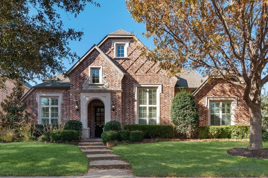 Five bedrooms, a resort-style saltwater pool, dual bonus rooms, and a 3-car garage, in Lantana, one of North Texas most awarded master-planned communities. This custom-built, two-story home delivers 4,688 sq ft of well-designed living on a corner lot, with a layout that puts both the primary suite and a private guest suite on the main floor. The entry opens to warm hardwood flooring and plantation shutters that carry through the main level. The living area anchors around a stone fireplace with gas logs and built-in cabinetry. The kitchen features granite countertops, a large center island, double ovens, butler's pantry, walk-in pantry, and abundant cabinetry. A serious cook's setup with room for everyone. The primary suite includes a sitting area, jetted soaking tub, separate shower, and dual sinks. A dedicated home office with built-in shelving is also on the main floor. Upstairs is a game room, a media room with projector and 120 inch screen, three additional bedrooms, and two full baths. The backyard delivers on every level with a saltwater pool with waterfall and spa, custom outdoor kitchen, covered patio with string lighting and ceiling fan, and mature landscaping that holds privacy year-round. Wine storage, a utility room with sink and storage, full security system, and dual-zone climate control round out the interior. Mechanicals include 2 new HVAC systems under 2 years old, tankless water heater, and a brand new pool pump. Lantana residents enjoy 5 community pools, 300 acres of greenbelts and trails, an 18-hole golf course, tennis courts, and The Shops at Highland Village just 5 miles away. 16 miles to DFW International Airport.