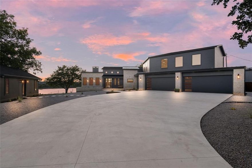 This EXTRAORDINARY lake house, designed and executed by Baker Elite Homes, is a perfect blend of modern sophistication and serene lakeside living, making it a dream home for those seeking both comfort and elegance.  You will enjoy 4,430 sqft of luxury living space in the main home overlooking panoramic views of the crystal clear waters of Lake Whitney! Every single room within this home has been intricately designed with high-end finishes that offers comfort as well as functionality within each space.  On the interior of the main home you will enjoy having 5 spacious bedrooms, 3 full bathrooms, floor-to-ceiling windows in the main space, a 12-foot kitchen island, fireplaces inside and out, an executive office space, wet bar, 2 large pantries, gym and much, much more. The guest house features 525 sqft with an open-concept, a full bath and is fully furnished.   The outdoor space from the gate to the lake is a DREAM and will take your breath away with each detail.  You will enjoy 2,600 sqft of outdoor living space that includes the pool, hot tub and massive covered back porch and patio area. A huge bonus and rarity about the property is the direct access you have to the lake.  Take the concrete steps right down to the water and enjoy kayaking, get on a boat or just watch the sunset with your feet in the water.  In addition to the beauty of this home's custom design, you will also love having the home fully furnished downstairs and outside so you are turn-key ready to start enjoying the good life on the lake.  This home is located on a dead-end street, has an additional half acre lot across the street, is just a golf cart ride away from the marina to store your boat and skis and is sure to ‘WOW’ every single person who comes through your front gate.