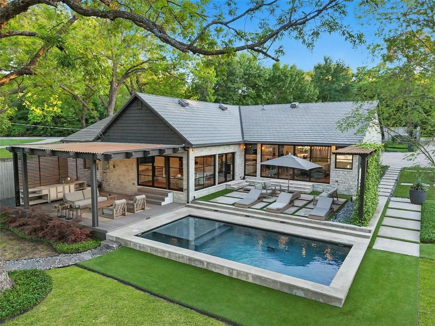 Lake Worh Lakefront Estate that will Take Your Breath Away. From the moment you pass through the private gate, you're transported into a serene lakeside sanctuary where luxury, comfort, & design converge in perfect harmony. Completely reimagined from the studs in, this meticulously crafted home offers the finest finishes & thoughtful details at every turn.The main residence features 3 spacious bedrooms, 3 full baths, & a dedicated study with private closet—perfect for a home office or optional 4th bedroom. The open-concept living area is an entertainer’s dream with soaring vaulted ceilings, a gas fireplace, built-in wet bar, & panoramic views of the outdoor oasis. At the heart of the home, the chef’s kitchen stuns with a massive marble island, farmhouse sink plus vegetable sink, custom cabinetry, built-in oversized refrigerator, &  premium gas cooktop. The luxurious primary suite is a true retreat, with windows on two sides showcasing pool & lake views. Spa-inspired primary bath & custom California closet elevate everyday living. Secondary bedrooms open to a private courtyard, offering tranquil privacy. Throughout the home, custom-made metal doors & windows create a seamless connection between indoor & outdoor spaces.  Step outside to your covered deck or unwind poolside. The guest house includes a full bath & sleeping loft, while an adjoining private workout room adds convenience. Two garages—an attached oversized 2-car & a detached, climate-controlled 2-car with half bath & lift-ready ceiling height—offer flexible utility.  Set on a beautifully landscaped lot with a putting green, fire pit, & expansive yard, leading down to your private shoreline with boat dock featuring dual lifts for both boat & jet skis. With an Italian ceramic tile roof, discreet storage areas, & every amenity thoughtfully placed, this extraordinary property must be seen to be truly appreciated. A once-in-a-lifetime opportunity for the discerning buyer seeking the ultimate lakeside lifestyle.