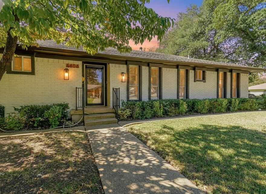 Zero out-of-pocket! Down payment help, seller pays closing to qualified buyers. Immaculate and fully renovated, this one-story corner lot home in Buckner Terrace offers 4 spacious bedrooms, 3 beautifully updated full baths, and an attached 2-car garage. From the moment you walk in, the open-concept layout with vaulted ceilings and designer-selected finishes welcomes you in. The chef’s kitchen is a true showstopper, featuring an 8ft x 4ft double waterfall island with Calacatta Sponda Quartz countertops (MSI, 3cm), stainless steel appliances, modern lighting, ample cabinet space, and a stunning designer backsplash. It flows effortlessly into a large living area with an accented brick fireplace, wooden mantel, and wood ceiling beams, perfect for everyday living and entertaining. The flexible dining area opens to the backyard through two separate doors, enhancing indoor-outdoor living. Durable luxury vinyl plank flooring, crisp white walls, and plenty of natural light create a fresh and inviting atmosphere across every room. The primary bedroom offers a walk-in closet w a luxurious en-suite bath with dual vanity sinks, an oversized glass-enclosed shower, and a freestanding acrylic soaking tub surrounded by elegant marble and porcelain tilework. Two additional bedrooms share remodeled full bathrooms, while a fourth bedroom with several windows and a large closet works well as a bright and cheerful office space. Outside, enjoy a fully fenced backyard with a new 8ft privacy wood fence and a covered patio, all set on an almost quarter-acre lot. Upgrades include a 2 year HVAC and duct system, updated plumbing and internal drains, a recently replaced electrical panel and wiring, and full energy-efficiency certification from the city. With no HOA and just 12 minutes from Downtown Dallas, this move-in ready home blends style, function, and location in one beautifully updated package. Hurry! Transferable Home warranty for the buyers with Choice Home warranty through 11.04.2026!