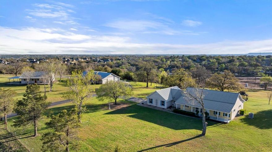 **Rare Small Ranch Living in Hood County** Welcome to one of those properties that makes you do a double-take — and then immediately start imagining your life here. Nestled on a quiet court where every property is a showpiece, this stunning five-bedroom, three-and-a-half-bath ranch sits on ten beautifully manicured, park-like acres that feel like your own private retreat. Step inside to a huge open living, dining, and kitchen area designed for both everyday comfort and effortless entertaining. The spacious primary suite offers a luxurious escape with a separate shower and garden tub. With a durable metal roof overhead, this home is built to last. But the main house is just the beginning. A separate brick guest house boasts stained concrete floors, stainless steel appliances, hickory cabinets, and charming front and back porches — perfect for visiting family or generating rental income. The incredible shop sits on a concrete slab and features a dedicated workshop area, covered parking, and additional separate storage. Whether you wrench on tractors or tinker with woodworking, this space delivers. Outside, the entire acreage is fully fenced with an electric entry gate, offering privacy and security for livestock, horses, or simply peace of mind. The heated-and-cooled covered back porch ensures year-round outdoor enjoyment regardless of what Texas weather throws your way. Oh, and did we mention? No homeowners association. Your land, your rules. Properties like this rarely come to market. Schedule your private tour before this gem disappears.
