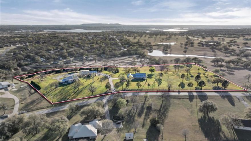 **Rare Small Ranch Living in Hood County** Welcome to one of those properties that makes you do a double-take — and then immediately start imagining your life here. Nestled on a quiet court where every property is a showpiece, this stunning five-bedroom, three-and-a-half-bath ranch sits on ten beautifully manicured, park-like acres that feel like your own private retreat. Step inside to a huge open living, dining, and kitchen area designed for both everyday comfort and effortless entertaining. The spacious primary suite offers a luxurious escape with a separate shower and garden tub. With a durable metal roof overhead, this home is built to last. But the main house is just the beginning. A separate brick guest house boasts stained concrete floors, stainless steel appliances, hickory cabinets, and charming front and back porches — perfect for visiting family or generating rental income. The incredible shop sits on a concrete slab and features a dedicated workshop area, covered parking, and additional separate storage. Whether you wrench on tractors or tinker with woodworking, this space delivers. Outside, the entire acreage is fully fenced with an electric entry gate, offering privacy and security for livestock, horses, or simply peace of mind. The heated-and-cooled covered back porch ensures year-round outdoor enjoyment regardless of what Texas weather throws your way. Oh, and did we mention? No homeowners association. Your land, your rules. Properties like this rarely come to market. Schedule your private tour before this gem disappears.