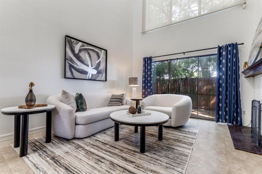 Experience sophisticated living in this stunning two-story condominium, offering 1,013 square feet of beautifully designed space with 1 bedroom and 1.5 baths. The expansive living room boasts dramatic 20-foot vaulted ceilings, a striking wood-burning fireplace, and custom built-in bookshelves that create an elegant yet inviting atmosphere. An architectural spiral staircase leads to a versatile loft with a built-in desk, ideal for a refined home office, guest suite, or second bedroom. The primary retreat opens to a private balcony, perfect for morning coffee or evening relaxation, while the spa-inspired full bath features an oversized shower for a touch of luxury. Completing this exceptional home is the convenience of an assigned carport with additional guest parking, all within the sought-after Dallas ISD zoning for Anne Frank Elementary, Benjamin Franklin Middle, and Hillcrest High. Designed for both comfort and style, this residence offers the perfect blend of sophistication, versatility, and convenience.