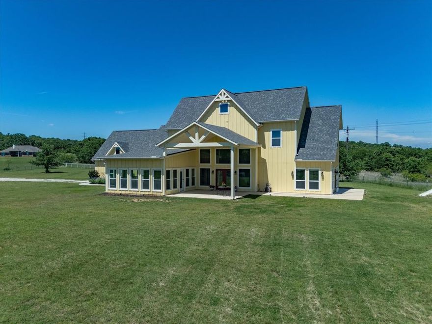 Discover country living at its finest in this exquisite 4-bedroom, 3-bathroom craftsman style home nestled on 5 acres of picturesque land in Sunset, TX. This stunning home boasts an abundance of natural light, tall ceilings, and exposed beams in the living room and kitchen, creating a warm and inviting atmosphere. The chef's kitchen features quartz countertops, stainless steel appliances, custom-built cabinets, and a walk-in pantry, perfect for culinary enthusiasts. Retreat to the primary bedroom downstairs, complete with an attached office, walk-in closet, and en-suite bathroom.  Upstairs, a spacious game room or second living room awaits, accompanied by two additional bedrooms and a full bathroom, providing ample space for family & guests. Downstairs off of the main living room there is the fourth bedroom and a second living room. The all window porch provides additional space to entertain and relax during all seasons. Enjoy peace of mind with an in-ground storm shelter. With lush trees, a fenced perimeter and all weather road this home offers privacy and tranquility at every turn. Don't miss your chance to experience the beauty of country living in this extraordinary property!