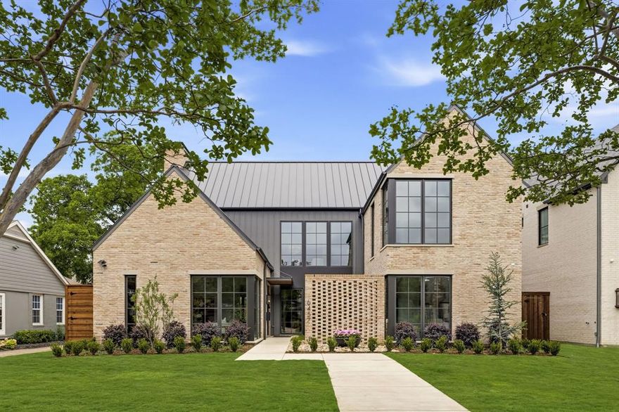 Architecturally striking new construction in the heart of Lakewood by Montgomery Custom Homes. 6457 Ellsworth Ave showcases refined transitional architecture, exceptional natural light, & thoughtful design throughout. With an emphasis on craftsmanship, scale, & livability, this home stands apart with elevated finishes & detailing rarely found in new construction. Stunning natural brick paired with a standing seam metal roof creates timeless curb appeal, while a beautifully turfed front courtyard offers privacy & a warm sense of arrival. Inside, a custom paneled entry sets the tone as dramatic floor-to-ceiling Lincoln Windows flood the home with natural light, including striking corner window details. The chef’s kitchen serves as the centerpiece of the home, featuring Wolf & Sub-Zero appliances, custom white oak cabinetry, layered plaster details, & an impressive working pantry. Just off the dining room, a sophisticated wet bar with Sub-Zero wine tower & ice maker is tucked behind reeded cabinetry, creating the perfect hosting setup.
The kitchen flows effortlessly into the living & dining spaces before opening through expansive sliding glass doors to the covered outdoor loggia, complete with fireplace & electric screens for year-round indoor-outdoor living. The resort-style backyard features a pool, spa, turf yard, outdoor kitchen & pool bath, creating a private retreat designed for entertaining and relaxation. A private study with vaulted ceilings, custom built-ins, & courtyard views offers a quiet workspace, while the primary suite delivers a spa-inspired experience with zellige tile, dual vanities, & a spacious walk-in closet. All secondary bedrooms feature en-suite baths & walk-in closets, while an upstairs game room overlooking both the front and backyard provides flexible additional living space. Additional highlights include Lutron lighting control throughout. Ideally located just moments from White Rock Lake and Lakewood’s premier shops and restaurants.