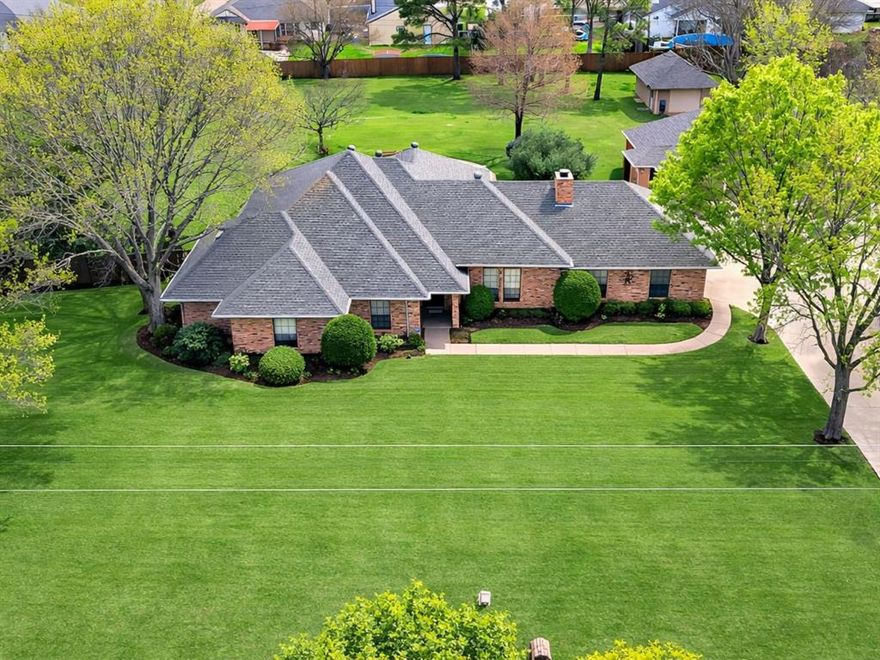 Situated on a beautiful 1-acre lot, this spacious 4-bedroom, 2-bath home offers a great layout, fantastic outdoor living, and a detached 3-car garage along with a separate workshop.

Upon entry, you’re welcomed by a spacious living area featuring a brick wood-burning fireplace, custom built-in cabinetry and shelving, and large windows that fill the room with natural light.

The kitchen is conveniently located just off the living area and features a large center island with breakfast bar seating, quartz countertops, built-in oven and microwave, an electric cooktop, and a spacious dining area with windows overlooking the backyard.

Just off the dining area, the oversized laundry room offers excellent cabinet and counter space along with plenty of room for a freezer or second refrigerator.

The primary suite features trayed ceilings and a cozy sitting area, along with an ensuite bathroom that includes a large dual-sink vanity, jetted tub, walk-in shower, split closets, and a skylight that allows for great natural lighting.

Off the living area is an additional space that adds excellent flexibility and can easily serve as a home office, game room, or flex space that is separate from the other bedrooms.

The fourth bedroom, located off the office room, is split from the additional bedrooms and features a large walk in closet. 

 French doors within the living room lead to the covered back patio, creating a seamless connection to the backyard. The patio overlooks the stunning in-ground pool and oversized backyard, perfect for relaxing or entertaining. The property also includes a separate workshop with electricity and a one-car garage door, ideal for lawn equipment, pool supplies, storage, or hobby use.

With 1 acre of space, a pool, a workshop, and a 3-car detached garage, this property offers a rare combination of comfort, functionality, and outdoor living.