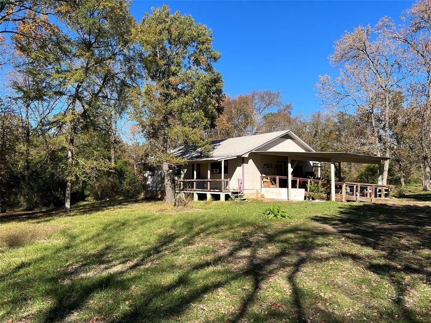 Home & acreage in beautiful Cottonwood area of FM 779. A winding, wooded drive leads to the 1-story home in an open area well off the road. A covered patio-carport area in front has access to kitchen. Enjoy morning coffee on the covered porch off the kitchen; in the evening unwind with wine on the covered porch off the living area! Large area for outdoor gatherings, lawn games, play areas for the kids. The possibilities are unlimited. The detached garage & 2 storage bldgs sit off to the side. Beyond the trees was a pasture where cattle grazed & drank from the pond. Seller no longer raises cattle so it's returned to more natural state but it can be restored. There's a timber exemption. Looking for income producing property? guest home, mother-in-law or adult child home? You've found it! A tiny home & storage shed are located at the front of the property PLUS a mobile home previously sat between the road and the main home. Each has its own septic, water & electric service. See it today!