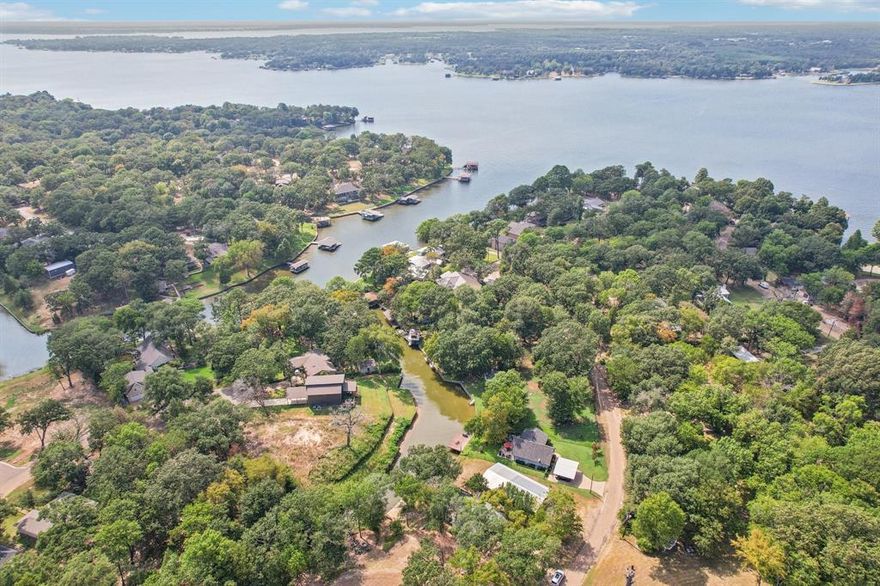 Seller offering $5,000 toward buyer closing costs or rate buydown! Enjoy true lakefront living at this charming Cedar Creek Lake cabin with its own private pier, along with access to a community boat ramp, lakeside park, and wide open-water views. Perfect for weekend escapes, full-time lake living, or a possible short-term rental opportunity (buyer to verify), this cozy retreat blends rustic character with vibrant, inviting décor. The open-concept living area features vaulted ceilings, a fireplace, and plenty of natural light. A modern kitchen makes cooking and entertaining easy, while the peaceful bedrooms offer comfortable spaces to unwind after a day on the water. Relax on the enclosed porch with morning lake breezes, spend afternoons boating or fishing from your private pier, and end your evenings on the deck or gathered around the outdoor fire pit. The private setting combined with unbeatable water access delivers the full Cedar Creek Lake lifestyle. Inviting, and loaded with rare lakefront features—this cabin is your perfect getaway on the water.