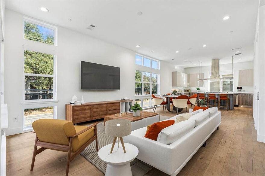 This modern corner unit at 3081 Chimes Street offers 2,871 square feet of thoughtfully designed living with 4 bedrooms, 4.5 bathrooms, a private two car garage, and a fenced front yard in one of Dallas’s most desirable locations. As a coveted corner unit, the home features additional windows throughout, creating a bright and open feel across all levels, while hardwood floors complement the seamless multi level floor plan ideal for both entertaining and everyday living. The layout includes two spacious living areas and an elevator with access to all four stories, along with window shades throughout for added comfort and privacy. The kitchen anchors the main living level with stainless steel appliances, a gas cooktop island, built in wine refrigerator, and custom cabinetry. Bedrooms are generously sized with abundant walk in closet space. Outdoor living is highlighted by a second floor covered patio and a fourth floor rooftop terrace with expansive downtown skyline views, offering an exceptional setting for relaxing and entertaining.