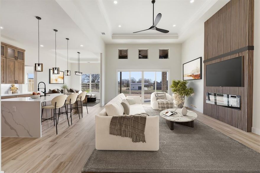 Experience peaceful country charm on a 1-acre homesite with this beautifully crafted residence with no HOA.  Designed to blend luxury with everyday livability, this 2,937 sq. ft. home with a 3-car side entry garage offers a serene setting with scenic views and a thoughtfully curated interior that feels both elegant and modern.  A welcoming front porch with space for rocking chairs and stunning iron double front doors with glass set the tone for the style and craftsmanship found throughout the home.  Inside, the grand living room impresses with soaring 13-foot tiered ceilings accented by LED lighting and a striking fluted wood fireplace that serves as the focal point. High-end slider doors flood the space with natural light and seamlessly connect the indoors to the covered patio, perfect for indoor-outdoor living. The entry and kitchen feature 11-foot ceilings, enhancing the home’s airy, open feel.  The kitchen is a true showpiece, showcasing quartz countertops, a dramatic waterfall quartz island, ceiling-height cabinetry with glass upper cabinets, and a gas cooktop with a convenient pot filler. A stunning butler’s pantry with glass cabinetry provides additional storage and prep space while adding a refined, custom touch. Two built-in desks in the home offer ideal spaces for working from home, managing daily tasks, or creating a dedicated homework station.  The split floorplan prioritizes privacy, with a serene primary suite set apart from the secondary bedrooms. The luxurious primary bath offers a spa-like retreat with designer finishes, dual vanities, an eye catching black freestanding soaking tub, a spacious walk-in shower, and an expansive custom closet with built-in shelving.  A desirable 3-car side-entry garage with a rear-oriented driveway adds both convenience and curb appeal.  Built for lasting quality, the home features a piered slab foundation supported by 30 engineered piers.