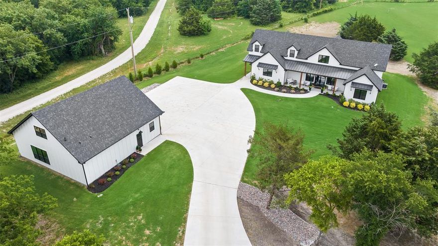 STUNNING CUSTOM RANCH ESTATE NESTLED ON 16.3 ACS IN THE COUNTRY! THE DRIVE UP IS TO DIE FOR. JUST OVER A YEAR OLD - SO IT'S BETTER THAN NEW, IT'S MOVE-IN READY - EVERYTHING YOU NEED IS ALREADY THERE. 3 SEPARATE LIVING QTRS. TOTAL 6349 SF+. NO HOA. IN THE COUNTY. PRIVATE POND with views of the creek & heavily trees. Enjoy the widelife as they graze in the pasture. Bring your horses or other animals, build a garden. THIS LUXURIOUS OPEN-CONCEPT HOME OFFERS SEVERAL TOUCHES OF CLASSY LIVING. GALLERY KITCHEN WITH COMMERCIAL APPLIANCE W.GAS STOVE, GIANT ISLAND WITH SEATING, EVERYTHING IS LITERALLY XL. Views everywhere you look. Breakfast room is precious. Back patio has dinning, living, & BBQ area with sink. Vaulted PRIMARY SUITE, such glamour is a dream. With his and her's separate walk-in custom closests, separate vanities, & separate shower & tub. The living room is really a GRAND-ROOM with equisite views a charming fireplace. Every bedroom is an ON-SUITE with walk-in closets. Upstairs offers a landing, bonusroom, XL Media-room connecting to full bath, & 4th On-suite BR with walk-in closet. 3 car garage with epoxy floors. 2nd living qtrs is connected to garage, it offers a full kitchen, all appliances, open concept living-room & BR, includes a full bathroom, walk-in closet with full size W.D. 50X60 Custom Muller BARN equipped with 3 rollup doors, plenty of shelves, upstairs storage loft, & additional concrete all around the barnquipment or adding on. 3rd living qtrs found in barn for ranch-hand or others. Full BR, kitchen space with frig, bathroom, & laundry. This sprawling adorable property offers many possiblities for your country dream in TEXAS.