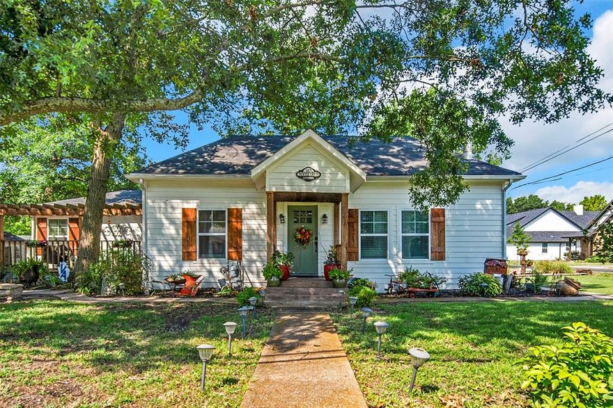 This charming 2-bedroom, 2-bath home sits on a beautifully landscaped lot with mature trees. The inviting curb appeal stands out immediately. Over the past several years, the home has been meticulously maintained and updated. Nine years ago, the current owner stripped the house to the studs, installed new insulation, all new windows, updated the wiring, leveled the foundation, and rebuilt the carport. The entire HVAC system was replaced in 2024. Both the deck and front porch have also been rebuilt. 
The spacious family room features a freestanding wood fireplace. Hardwood floors run throughout the living, dining, and kitchen areas. The floor plan includes a 13x13 flex room, currently used as a dining and play room. 
The primary bedroom measures 16x16 and features an ensuite bath. The second bedroom, 13x12, is across the hall from the second full bath, which offers a walk-in shower with grab bars. The washer and dryer are a stacked unit included with the home. The attached carport accommodates two cars. An additional powered building with a window unit provides extra versatility. The lot has french drains and a sump pump to keep any water from ponding in the yard. This home is centrally located in Van Alstyne, within walking distance of the vibrant downtown. Van Alstyne is a welcoming small town with numerous restaurants and shops, frequent festivals, free outdoor concerts in the social district amphitheater, and a weekly farmer’s market. Multiple city parks are located throughout town. Van Alstyne ISD is award-winning. The Nextdoor app rates Van Alstyne with an A for low crime and an A+ for housing prices. This darling home is a rare opportunity to buy a quality home for under $300,000.