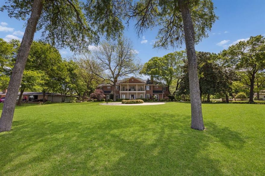 Set on a rare 1+ acre estate overlooking White Rock Lake, this timeless traditional residence captures panoramic sunset views of the Downtown Dallas skyline in one of East Dallas’ most iconic and sought-after locations. Custom built in 2004, the home offers a thoughtfully designed floor plan ideal for both refined living and entertaining, featuring two primary suites (one on each level), four additional bedrooms, and elegant formal spaces anchored by multiple fireplaces. At the heart of the home, a beautifully appointed kitchen opens seamlessly to both the breakfast area and family room, creating a natural gathering space framed by expansive windows that showcase the surrounding grounds and views. Throughout, exceptional millwork and custom carpentry reflect a level of craftsmanship rarely found, offering warmth, character, and enduring quality. The outdoor setting is equally impressive, with a resort-style pool, gazebo, and greenhouse, creating a private retreat for relaxation, entertaining, and year-round enjoyment. A gated side entrance leads to a motor court and a rare four-car garage, providing both privacy and convenience. With its elevated setting, expansive acreage, and unobstructed views of White Rock Lake and the Dallas skyline, this is a truly rare opportunity to own a legacy property in one of East Dallas’ most prestigious settings.  Contact listing agent Lee Lamont or your realtor for a private showing.