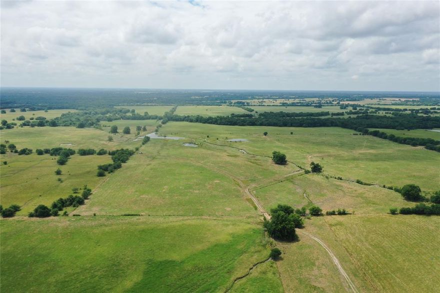 This 407.11 acre tract in southern Fannin County is a very unique offering! Less than 2 miles from the currently being constructed Lake Ralph Hall, tracts of this size and frontage are rarely offered for sale. The property boasts 2300 of Hwy 34 frontage and 1450 of CR 3900 frontage, allowing for easy future divisibility. All of the fencing on Hwy 34 and on both sides of the driveway entering into the old farm headquarters are of pipe and cable construction. The property has a very desirable appearance from the highway. The acreage has been historically used for cattle production and fencing and corrals are in place.  The property is approximately 90% open pasture with mature tree cover along the Middle Sulphur River and scattered throughout the pastures for shade.