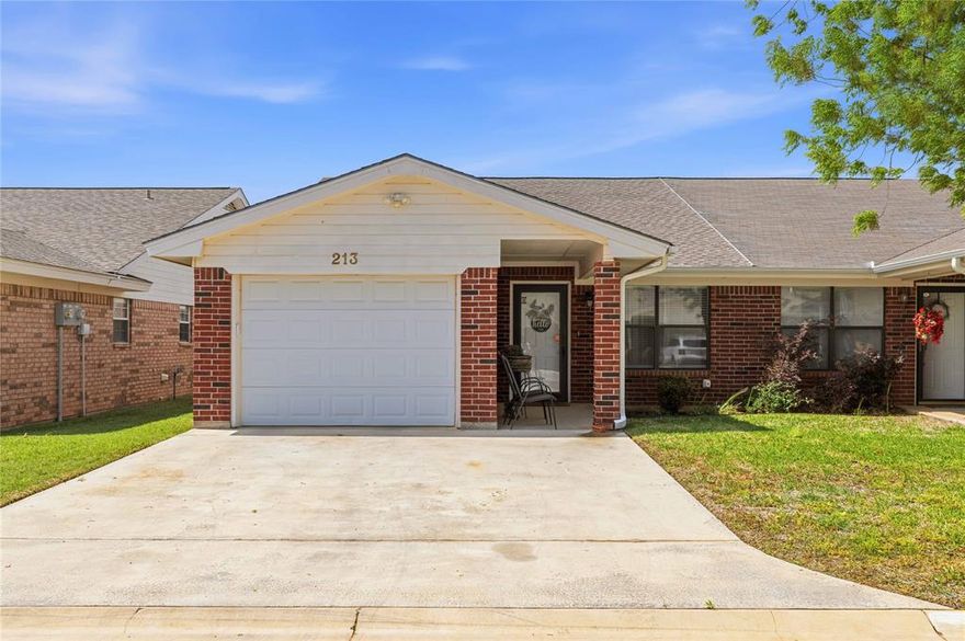 Low-maintenance living in the desirable Ridgewood Gardens 55+ community in Early, Texas! This charming duplex at 213 Wills Way offers comfort, convenience, and thoughtful updates throughout. Step inside to find a beautifully refreshed interior featuring vaulted ceilings, granite countertops, durable vinyl plank flooring, and a functional layout designed for easy living. A beautiful kitchen is the heart of the home with peninsula barstool dining and plenty of room to entertain. In addition to the main living area, a versatile bonus room provides the perfect space for a hobby room, home office, or second living area—tailored to fit your lifestyle. Enjoy peace of mind with a roof replaced in 2024, along with the added benefit of an attached one-car garage for convenience and storage. Living in Ridgewood Gardens means truly carefree homeownership—HOA services include yard maintenance, sprinkler system care, water, sewer, trash, and pest control, allowing you to spend more time enjoying what matters most. Whether you’re downsizing or seeking a relaxed, community-focused lifestyle, this move-in ready home is a fantastic opportunity in a sought-after 55+ neighborhood. Call today to schedule a private showing!